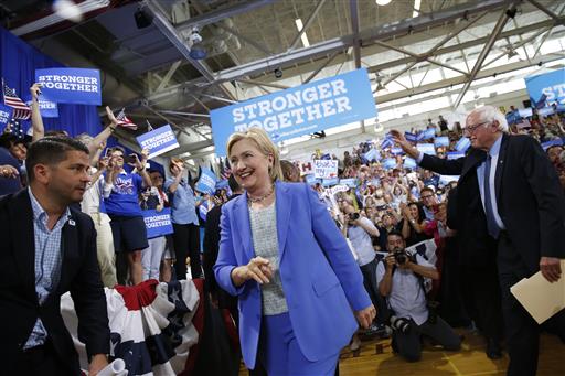 Democratic presidential candidate Hillary Clinton, followed by Sen. Bernie Sanders, I-Vt., arrives for a rally in Portsmouth, New Hampshire, Tuesday, July 12.