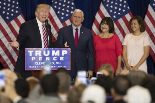 Republican presidential candidate Donald Trump, speaks at a reception with friends and family following the Republican National Convention, Friday, July 22, 2016, in Cleveland. Listening are vice presidential running mate Gov. Mike Pence, R-Ind., Karen Pence, and Charlotte Pence. (AP Photo/Evan Vucci)