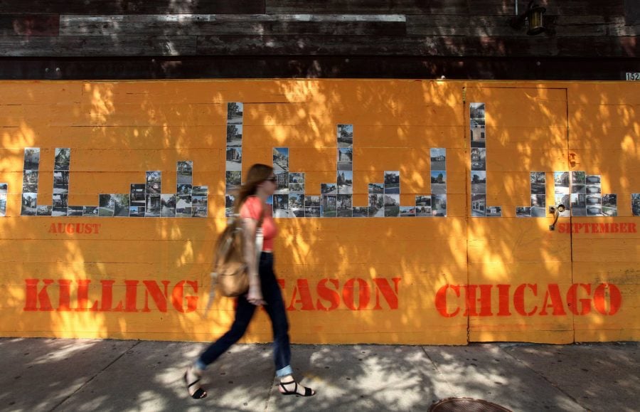 A+woman+walks+by+the+installation+Killing+Season+Chicago+on+the+outside+of+The+Violet+Hour+in+Wicker+Park.+The+installation+began+in+2011.+%28Heather+Charles+%7CChicago+Tribune+%7CMCT%29