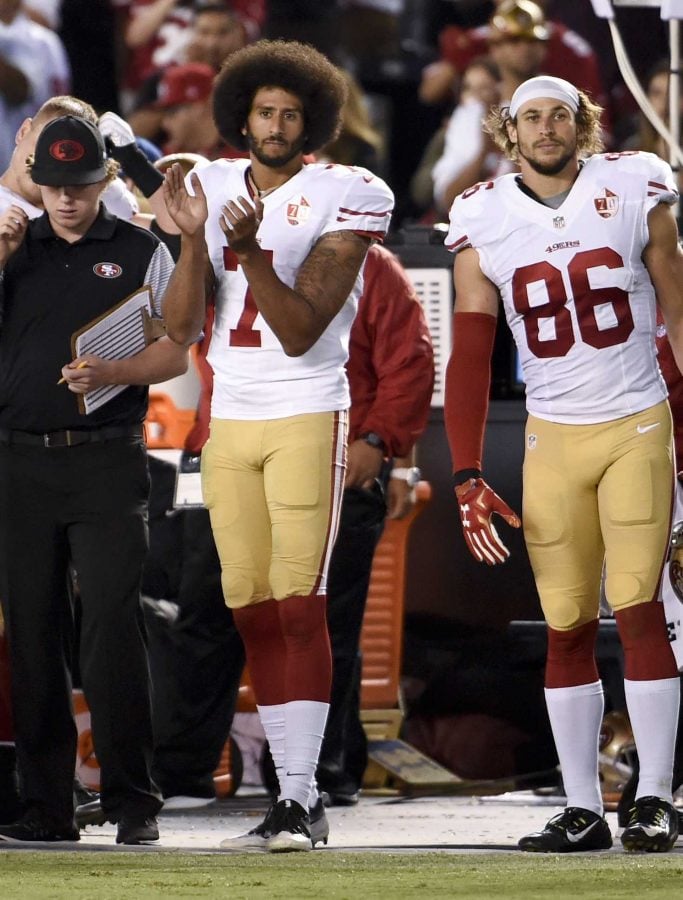 San Francisco 49ers quarterback Colin Kaepernick applauds during the playing of "God Bless America" during the second half of an NFL preseason football game against the San Diego Chargers, Thursday, Sept. 1, 2016, in San Diego. (AP Photo/Denis Poroy)