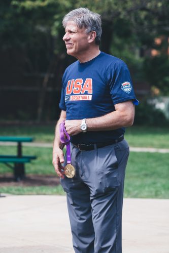 Doug Bruno looks on to the speaker, holding his gold medal. (Josh Leff/The DePaulia)