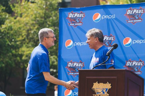 Doug Bruno shakes DePaul President Rev. Dennis Holtschneider, C.M.'s hand at Tuesday's event. (Josh Leff/The DePaulia)