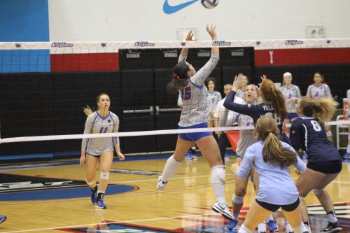 Senior setter Colleen Smith sets the ball up for junior middle blocker Caitlyn Coffey to send over. (Photo by Caroline Stacey / The DePaulia)