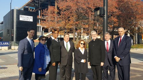 Members of the DePaul University administration and Metropolitan Pier and Exposition Authority pose in front of Wintrust Arena. (Ben Gartland/The DePaulia)