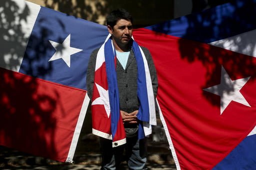 A man stands before a Cuban and Chilean flag displayed outside Cubas embassy in Santiago, Chile, Saturday, Nov. 26, 2016, the day after Fidel Castros death. Castro, who led a rebel army to improbable victory, embraced Soviet-style communism and defied the power of 10 U.S. presidents during his half century rule of Cuba, died at age 90 in Cuba late Friday, Nov. 25. (Esteban Felix | AP Photo)