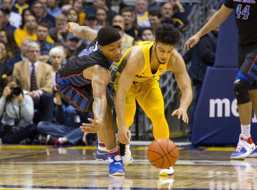 Marquette guard Markus Howard, right, and DePaul guard Devin Gage, left, fight for a loose ball during the second half of an NCAA college basketball game Saturday, Jan. 14, 2017, in Milwaukee. (AP Photo/Darren Hauck)