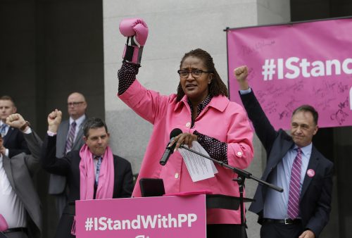 Wearing a pink boxing glove, Sen. Holly Mitchell, D-Los Angeles, called on supporters of Planned Parenthood to raise their fists in support of the organization, at the Capitol Pink Out Day 2017 rally Tuesday, Jan. 17, 2017, in Sacramento, Calif. Proponents rallied against House Speaker Paul Ryan's budget bill which would halt federal funding for Planned Parenthood. (AP Photo/Rich Pedroncelli)