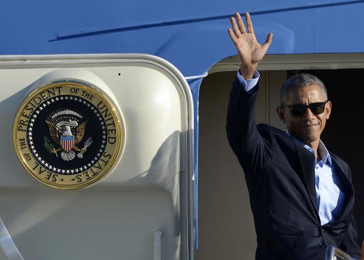 FILE - In this Oct. 9, 2016 file photo, President Barack Obama, wearing sunglasses, waves while boarding Air Force One before leaving OHare International Airport in Chicago. From his campaign fist bump to his theatrical mic drop at the last White House correspondents’ dinner, Barack Obama ruled as America’s pop culture president. His two terms played out like a running chronicle of the trends of our times: slow-jamming the news with Jimmy Fallon, reading mean tweets with Jimmy Kimmel, filling out his NCAA basketball bracket on ESPN, cruising with Jerry Seinfeld on “Comedians in Cars Getting Coffee.”  (AP Photo/Paul Beaty, File)