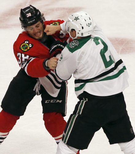 Chicago Blackhawks left wing Ryan Hartman, left, fights with Dallas Stars defenseman Dan Hamhuis during the second period of an NHL hockey game Thursday, March 23, 2017, in Chicago. (AP Photo/Nam Y. Huh)