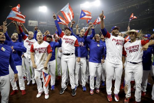 Members of the Puerto Rico team celebrate after defeating the United States 6-5 in a second-round World Baseball Classic baseball game Friday, March 17, 2017, in San Diego. (AP Photo/Gregory Bull)