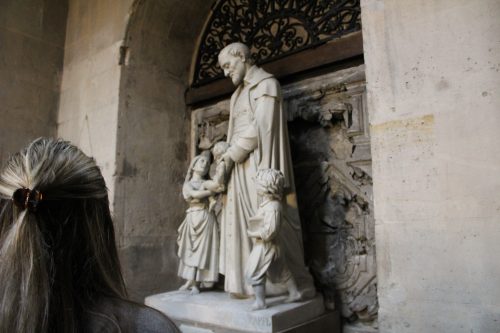 SGA Senator of Mission and Values, Gracie Covarrubias, looks on at a statue of St. Vincent de Paul at the Motherhouse of the Congregation of the Mission in Paris, France. 