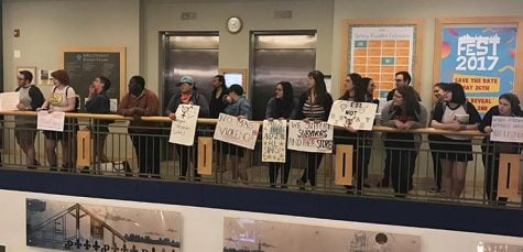 Demonstrators filed into the Student Center holding signs and repeating chants before circling up around the atrium on Thursday.