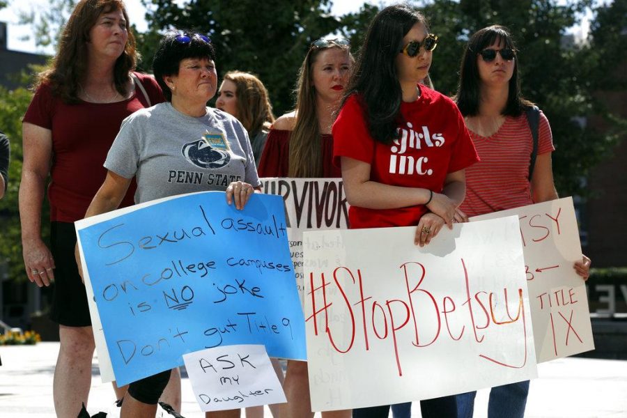 Sonja Breda, 23, right, holds a sign saying Stop Betsy as a group of survivors of sexual violence and their supporters gather to protest proposed changes to Title IX before a speech by Education Secretary Betsy DeVos, Thursday, Sept. 7, 2017, at the George Mason University Arlington, Va., campus. (Jacquelyn Martin, The DePaulia)