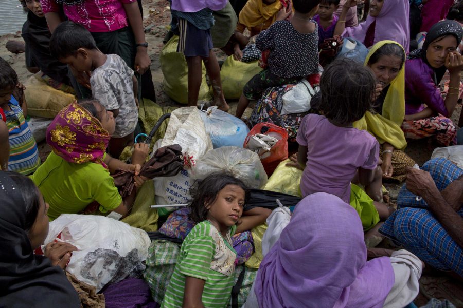 A Rohingya Muslims girl rests on a pile of bags, as she waits with others to walk towards a camp for refugees after crossing into Bangladesh from Myanmar, in Teknaf, Bangladesh, Friday, Sept. 29, 2017. More than a month after Myanmars refugees began spilling across the border, the U.N. says more than half a million have arrived. The prejudice and hostility that Rohingya Muslims face in Myanmar stretch beyond the countrys notoriously brutal security forces to a general population receptive to an often-virulent form of Buddhist nationalism that has seen a resurgence since the end of military rule. (AP Photo/Gemunu Amarasinghe)