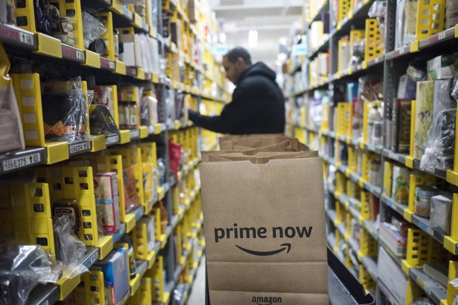 FILE-A clerk picks up items for customer orders at the Amazon Prime warehouse in New York in this Dec. 20, 2017 photo. Amazon announced it has narrowed down  the list for potential sites for a second headquarters in 20 U.S. and Canadian cities.  (Mark Lennihan | AP)