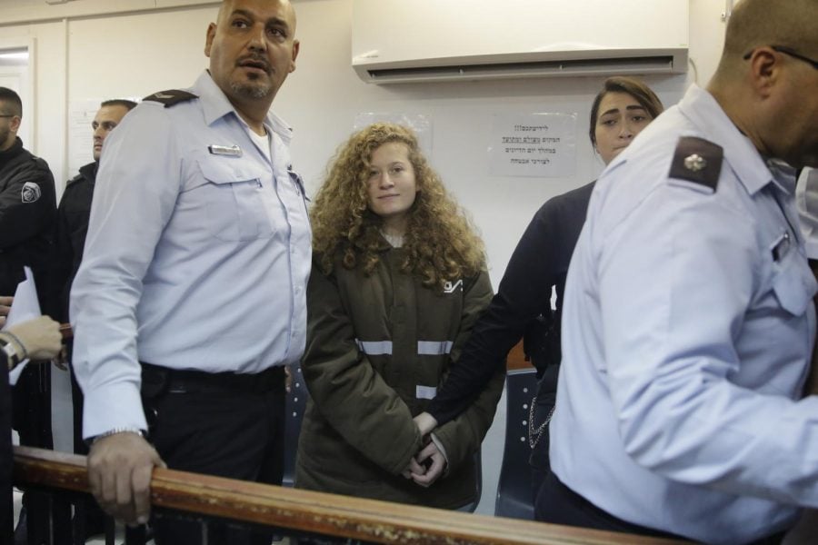 Ahed Tamimi is brought to a courtroom inside the Ofer military prison near Jerusalem, Monday, Jan. 15, 2018. Tamimi, 16, was filmed in December pushing, kicking and slapping Israeli soldiers, who stood by silently.  (Mahmoud Illean | AP)
