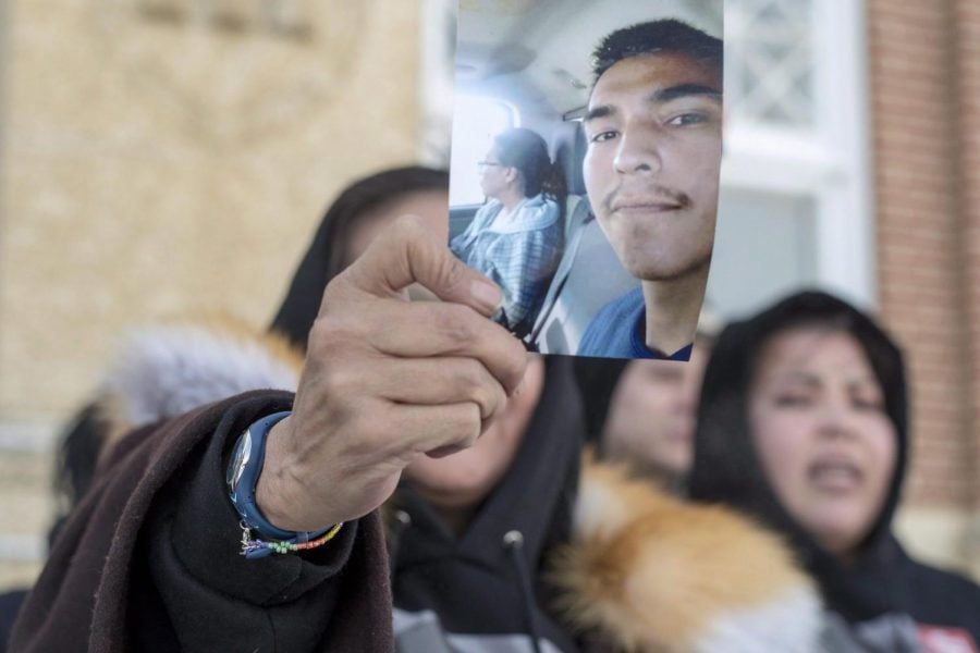 Debbie Baptiste holds up a picture of her son, Colten Boushies on the fifth day of the trial of Gerald Stanley, the farmer accused of killing the 22-year-old Indigenous man, in Battleford, Saskatchewan on Feb. 5, 2018. (Liam Richards | The Canadian Press via AP)