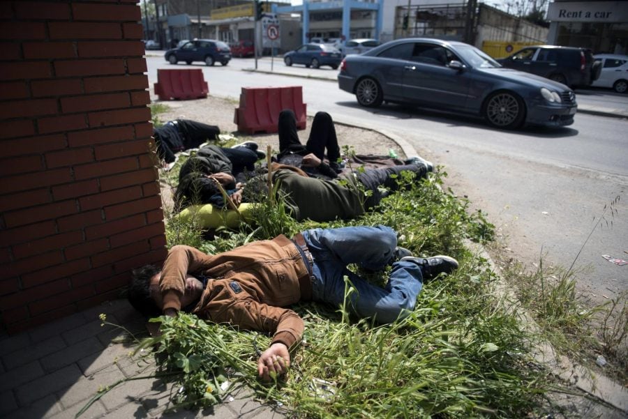 Migrants sleep outside the police headquarters at the northern Greek city of Thessaloniki, Friday, April 13, 2018. Several hundred refugees and migrants have gathered outside a police station in Greeces second largest city, waiting for hours to be formally arrested and gain temporary residence in the European Union country. 