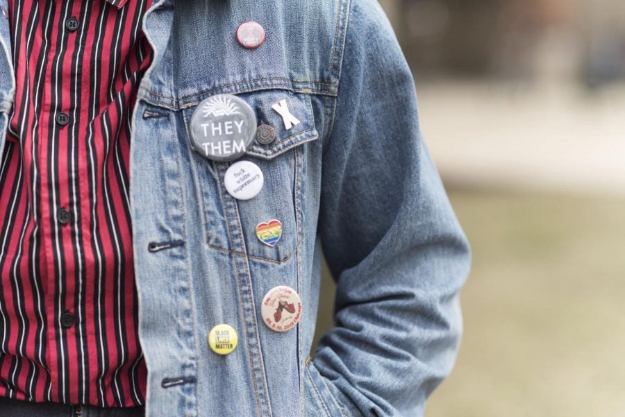 Holtzs denim jacket features pins related to nonbinary gender identities and they/them pronouns.
Cody Corrall | The DePaulia