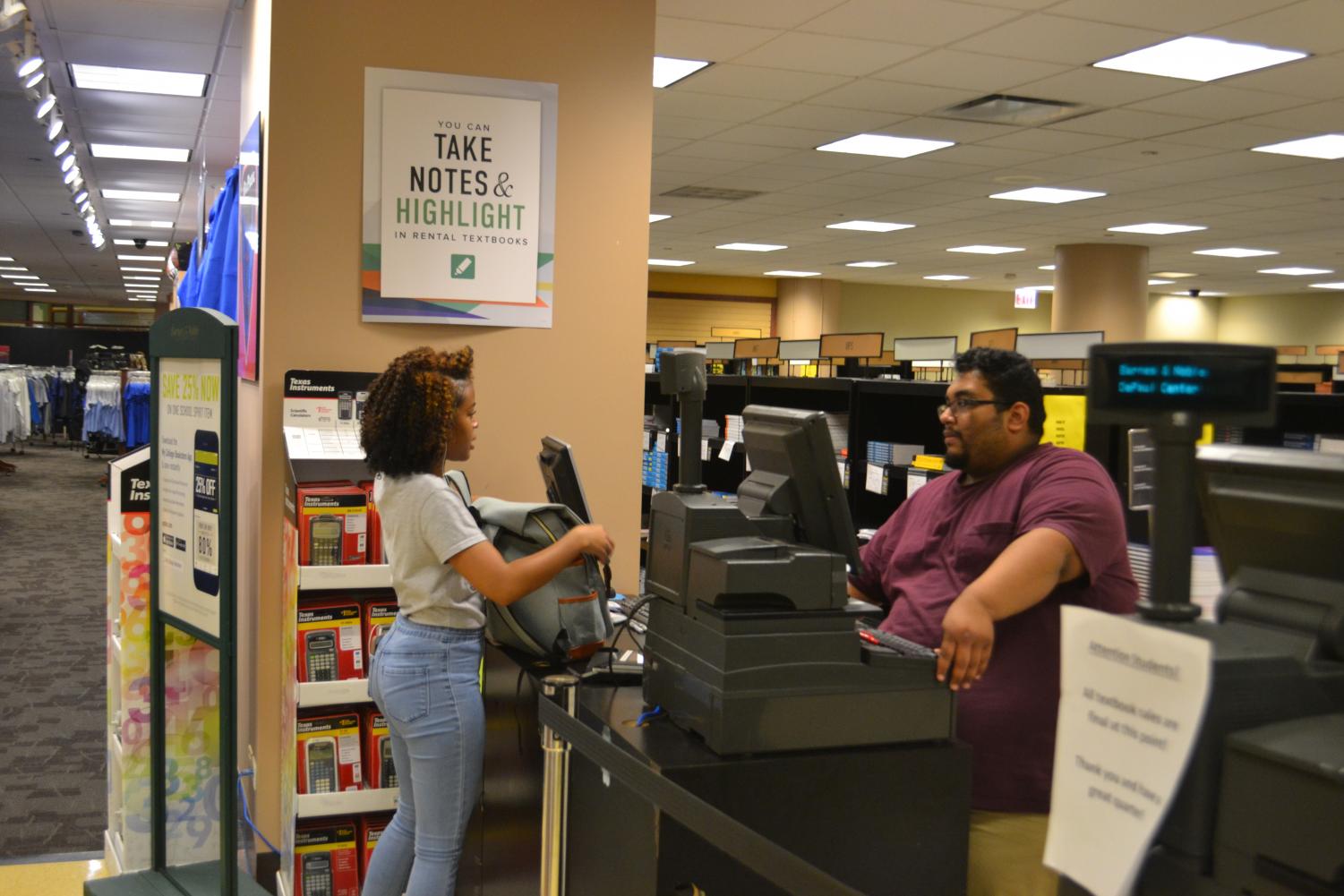 A DePaul student conducts a transaction at DePaul's Loop Campus bookstore. Many students have advocated for open source textbooks due to pricing.