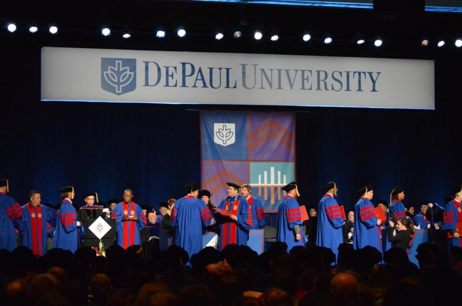 President Esteban congratulates graduates of the law school as they step forward to earn their diploma. Commencement was at the McCormick Grand Ballroom instead of Wintrust Arena.