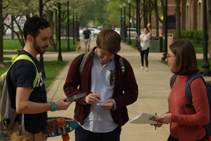 Seamus O’Connor, Sam Tomko-Jones and Ally Sledz going over registered voter tallies.