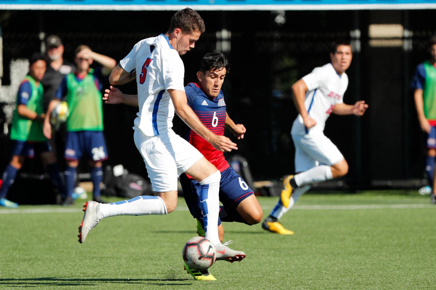 DePaul midfielder Joshua Bowser fights for a ball with UIC midfielder Nestor Garcia in the first half of DePaul's 2-0 loss to the Flames. Photo Courtesy of DePaul Athletics