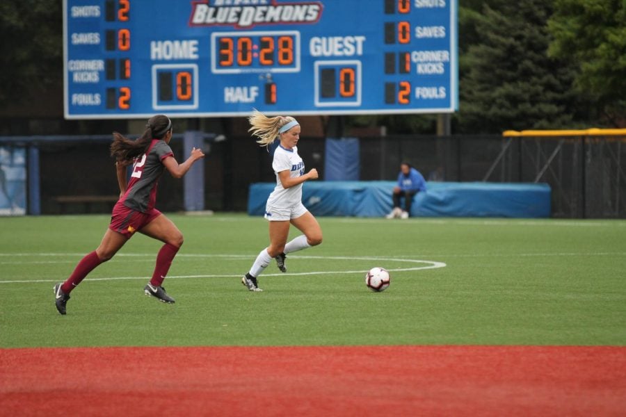 Senior Franny Cerny races past Loyola midfielder Abby Swanson while picking up an assist for DePaul’s only goal in a 1-0 win.  Xavier Ortega | The Depaulia