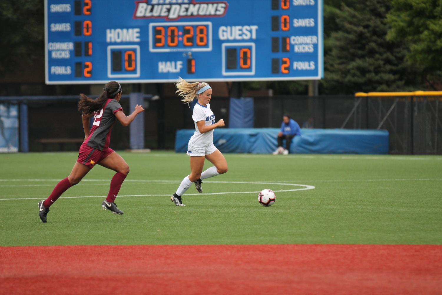 Senior Franny Cerny races past Loyola midfielder Abby Swanson while picking up an assist for DePaul’s only goal in a 1-0 win. Xavier Ortega | The Depaulia