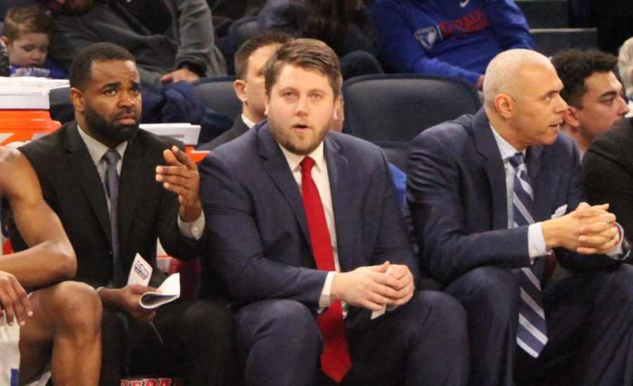 DePaul assistant coaches Tim Anderson and Shane Heirman sit next to DePaul head coach Dave Leitao.