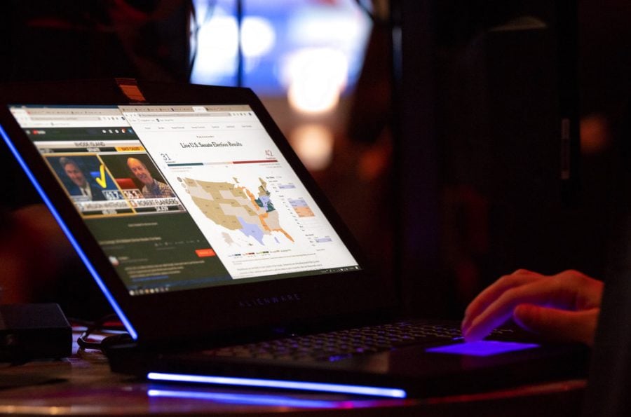 Early election results are displayed on a computer screen during the Dallas County Republican Party election night watch party on Tuesday, Nov. 6, 2018, at The Statler Hotel in Dallas. (AP Photo/Jeffrey McWhorter)