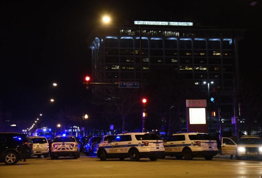 Associated Press | Responding officers to the Mercy Hospital shooting. 