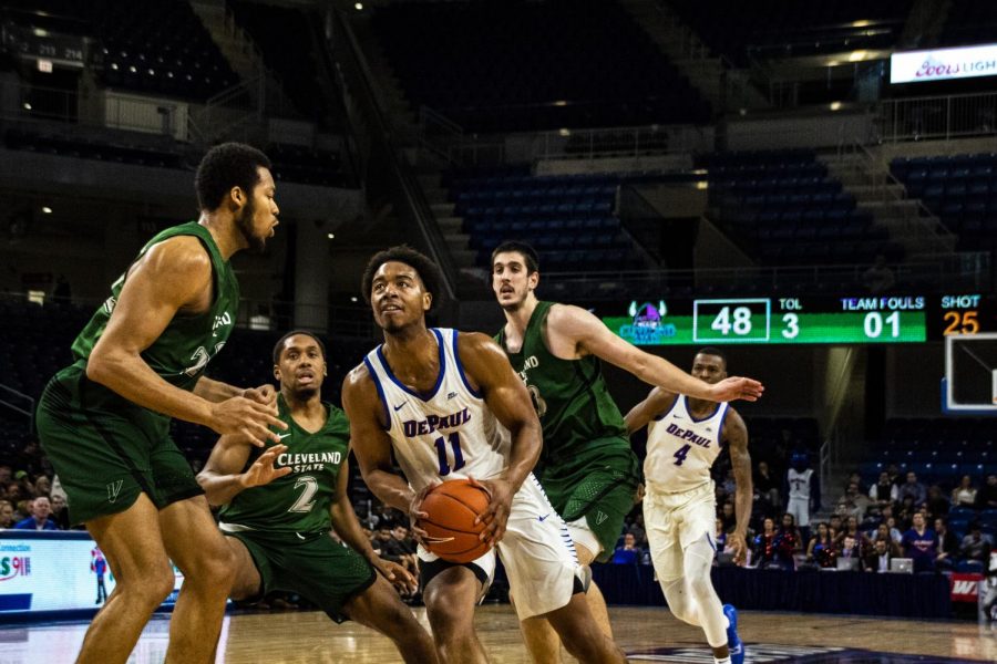 DePaul senior guard Eli Cain drives to the rim with Cleveland State defenders Jaalam Hill (left), Kasheem Thomas (center) and Stefan Kenic (right) looking on. Richard Bodee | The DePaulia