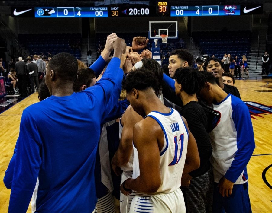 The DePaul Blue Demon mens basketball team huddles before a game. [Richard Bodee-The DePaulia]