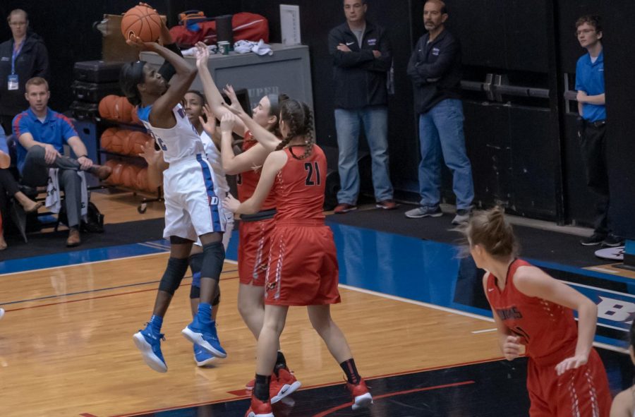 DePaul junior Chante Stonewall shoots over St. Xavier freshman center McKenna Zobel and senior center Emily Gorsch during DePauls win St. Xavier. 
Jonathan Aguilar | The DePaulia