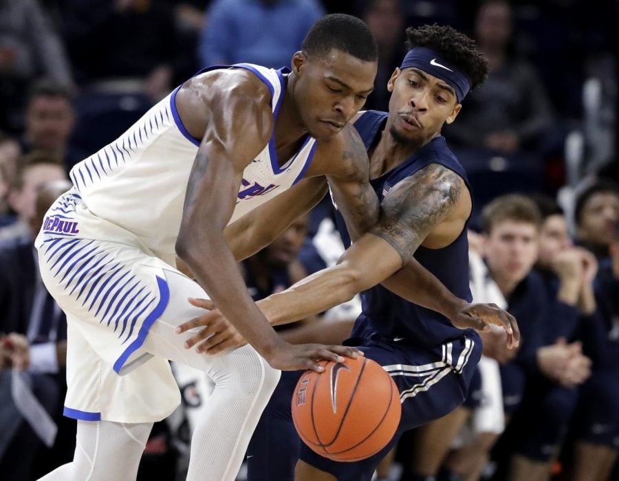 DePaul forward Paul Reed, left, drives against Xavier guard Paul Scruggs during the first half of an NCAA college basketball game Saturday, Dec. 29, 2018, in Chicago. Nam Y. Huh | AP