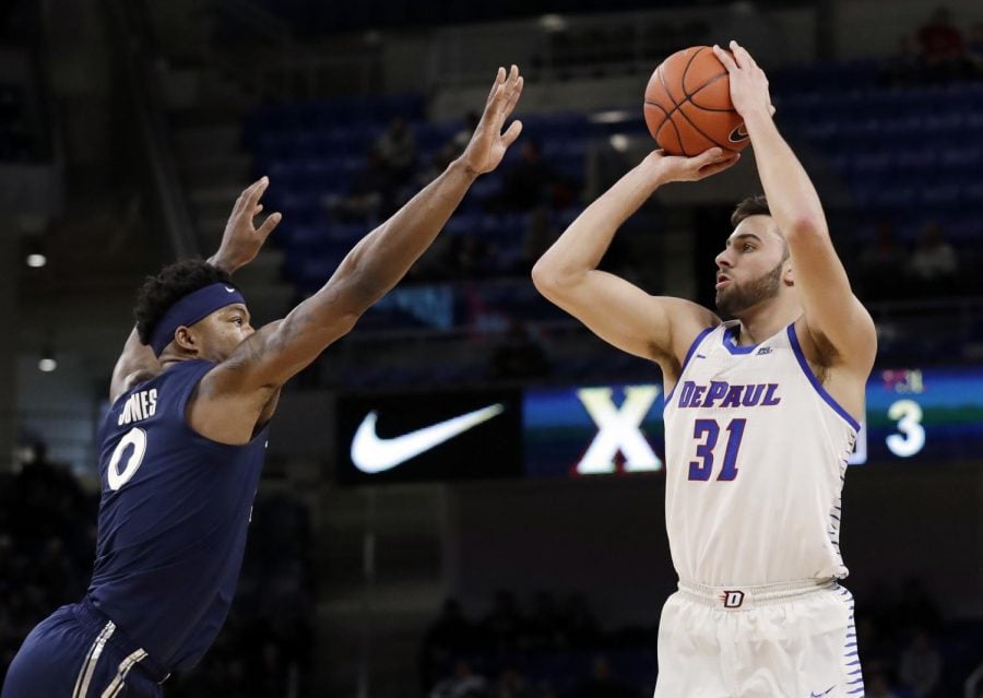 DePaul forward Max Strus, right, shoots against Xavier forward Tyrique Jones during the second half of an NCAA college basketball game Saturday, Dec. 29, 2018, in Chicago. Xavier won 74-65. Nam Y. Huh | AP