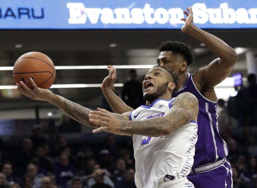 DePaul guard Devin Gage, left, drives to the basket past Northwestern guard Anthony Gaines during the first half of an NCAA college basketball game Saturday, Dec. 8, 2018, in Evanston, Ill. Nam Y. Huh | AP