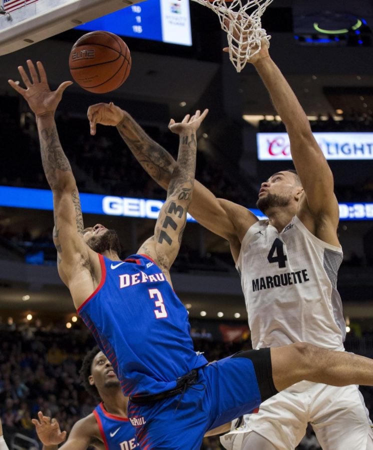 Marquette forward Theo John, right, defends against DePaul guard Devin Gage, left, during the second half of an NCAA college basketball game, Wednesday, Jan. 23, 2019, in Milwaukee. Darren Hauck | AP 