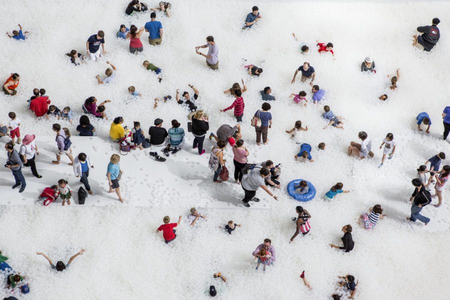 Attendees dive into "The Beach," an interactive art exhibit open now until Feb 3. 