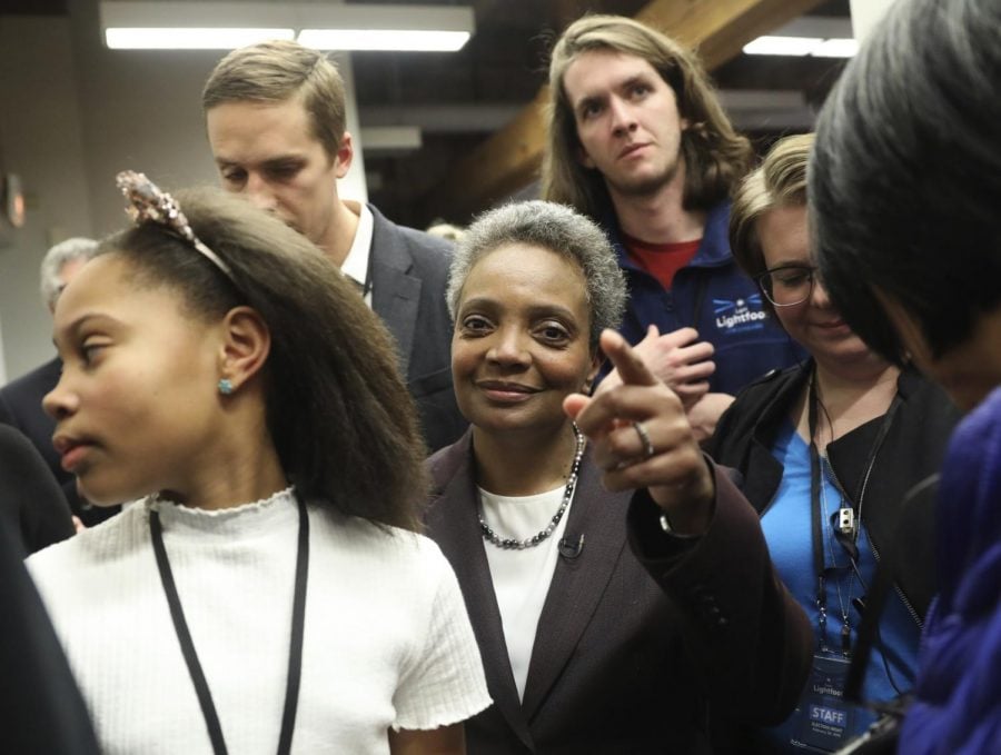 Mayoral candidate Lori Lightfoot and her daughter Vivian Lightfoot appear with supporters at EvolveHer in Chicago Tuesday, Feb. 26, 2019. (Erin Hooley/Chicago Tribune via AP)
