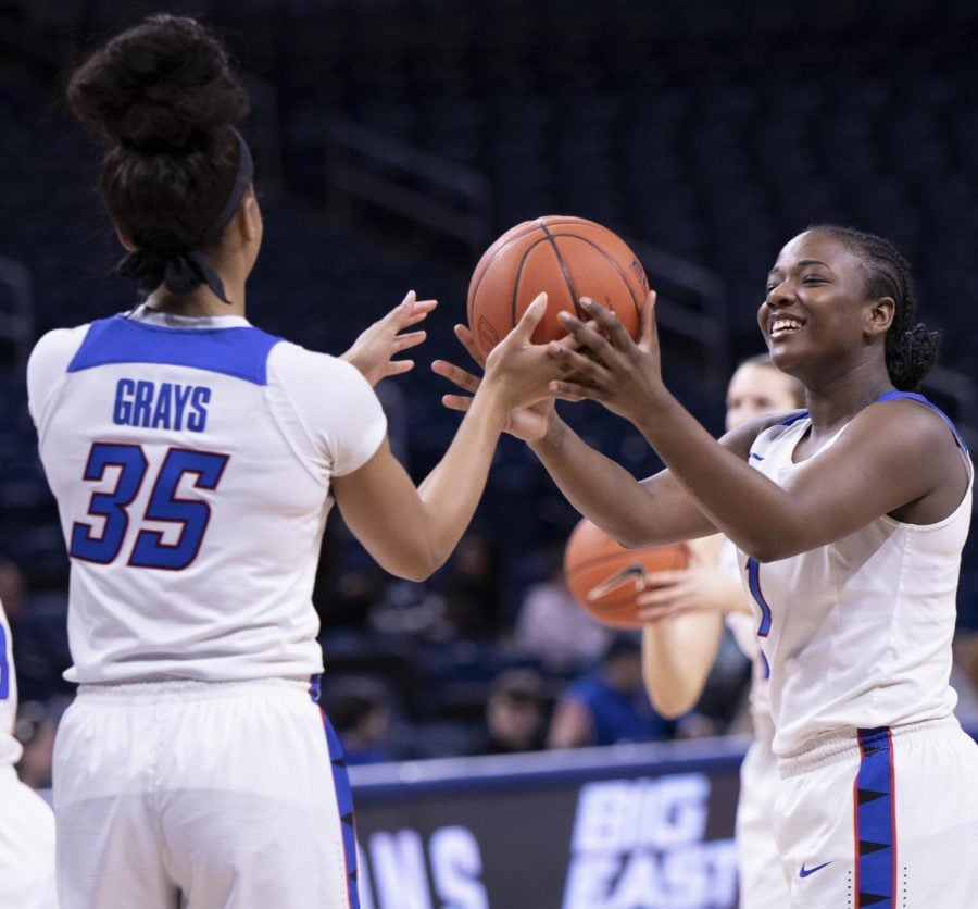 DePaul senior guard Ashton Millender jokingly hands the ball over to fellow senior Mart’e Grays during warmups of DePaul’s Feb. 22 game against Xavier at Wintrust Arena. 