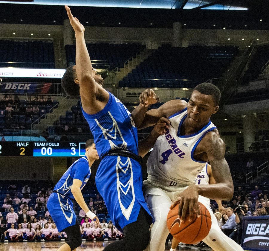 DePaul sophomore forward Paul Reed backs down Creighton guard Ty-Shon Alexander Wednesday night at Wintrust Arena. The Blue Demons lost the game 79-67. 