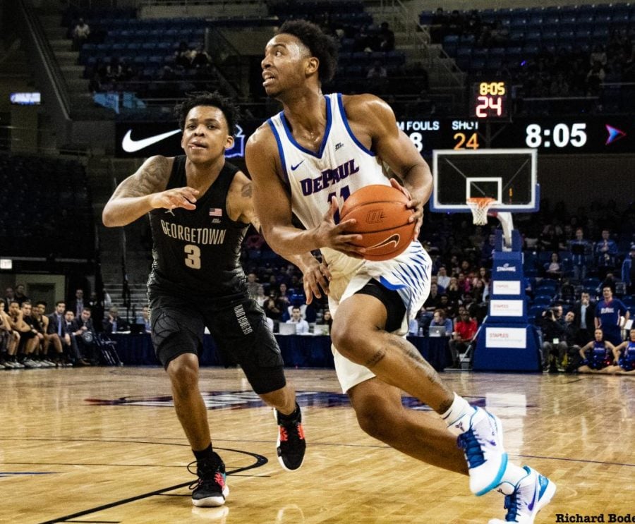 DePaul senior guard Eli Cain drives to the basket against Georgetown freshman James Akinjo on March 6 at Wintrust Arena. The Blue Demons square off against Central Michigan in the first round of the CBI tournament on Wednesday at 7 p.m. Richard Bodee I The DePaulia 