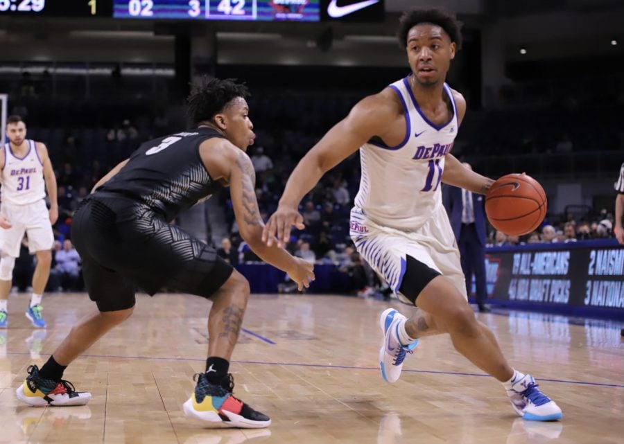 DePaul senior guard Eli Cain drives past Georgetown freshman guard James Akinjo during a March 6, 2019 game against Georgetown. 