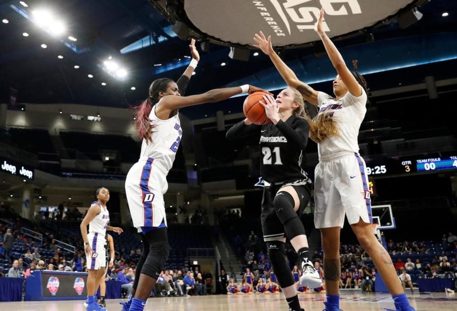 DePaul junior forward Chante Stonewall blocks a layup attempt by Providence senior Maddie Jolin during the third quarter of the Blue Demons win over the Friars Sunday night at Wintrust Arena. Steve Woltmann/BIG EAST 