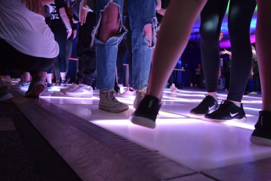 Dancers stand on the light up floor. DemonTHONs dance marathon requires dancers to be standing for 24 hours. Amy Do / The DePaulia