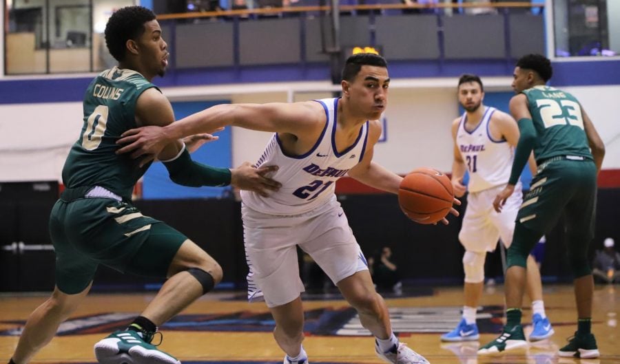 DePaul freshman guard Flynn Cameron drives past USFs David Collins during game two of the CBI championship series. 