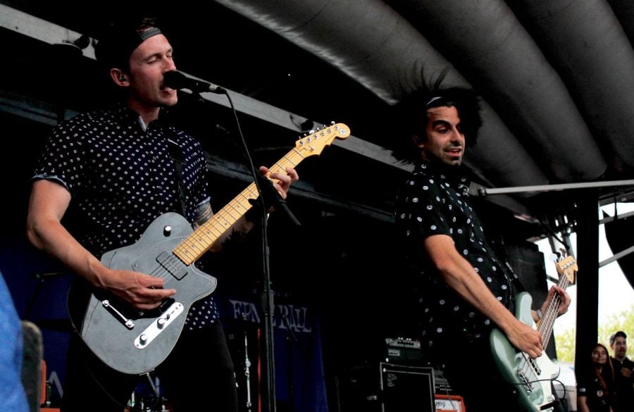 DePaul graduates TJ Horansky and AJ Khah on stage during their performance at Warped Tour as part of their band Sleep on It.