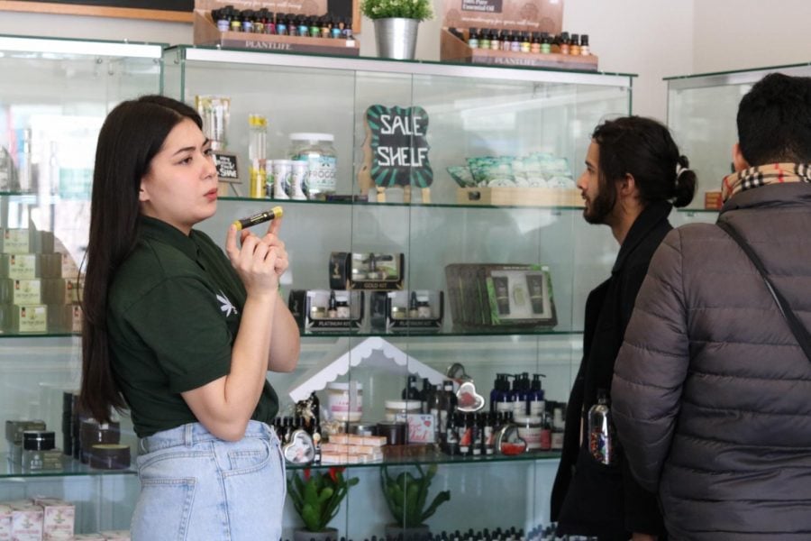 Danielle Larson, manager of CBD Kratom in Lakeview, gives customers the sales pitch on the stores products. 
